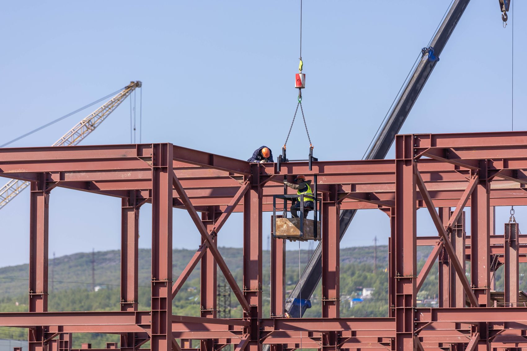 Crane setting a structural steel frame